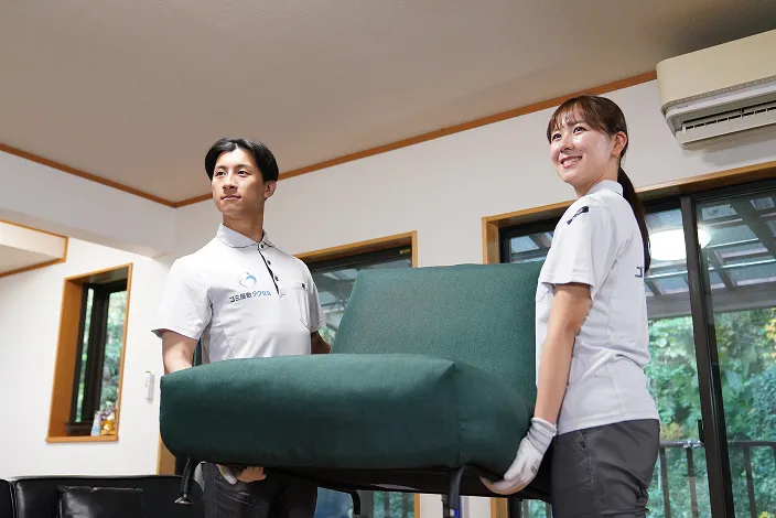ゴミ屋敷タクセル東京のスタッフ2名がソファーを運んでいる画像
